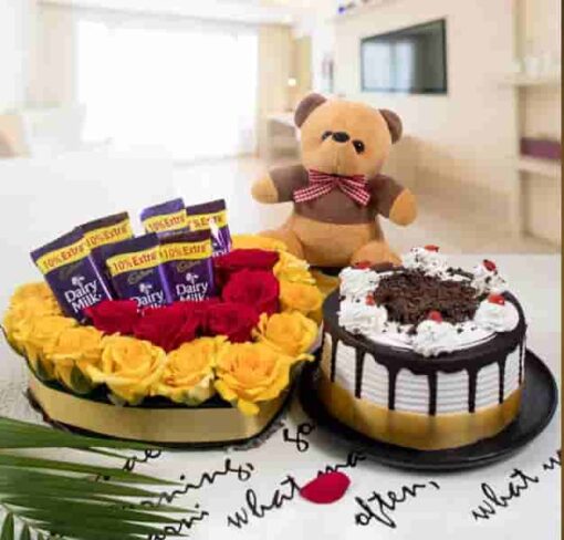 Thoughtful gift bundle with gourmet treats, flowers, and personalized items.