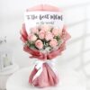 Pure Love Mother's Bouquet with creamy white roses, ranunculus, green hydrangeas, and chamomile in a natural wrap