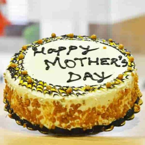 Golden Love Mom Cake – beautifully decorated butterscotch cake with “Mom” written on top, golden caramel drizzle, and floral frosting accents, perfect for Mother’s Day.
