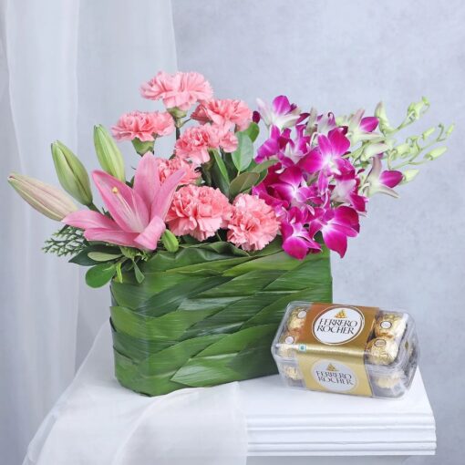Vibrant bouquet of mixed-color carnations paired with rich gourmet chocolate cake and hot chocolate mix in an elegant gift set