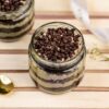 Chocolate cream cake jars layered with sweet cream and chocolate chips in clear glass jars