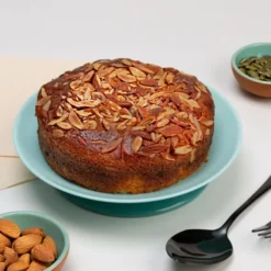 Rich Fruit Dry Cake with visible dried fruits and nuts, sliced on a festive serving plate