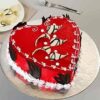 Heart-shaped Black Forest cake decorated with whipped cream, cherries, and chocolate shavings.