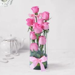 Enchanting Pink Rose Display featuring fresh pink roses elegantly arranged in a clear vase, ideal for romantic and family celebrations.