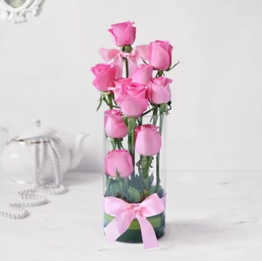 Enchanting Pink Rose Display featuring fresh pink roses elegantly arranged in a clear vase, ideal for romantic and family celebrations.