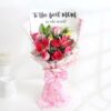 Exotic Mom Bloom Bouquet with 9 assorted flowers including lilies, roses, and gypsophila wrapped in pink paper