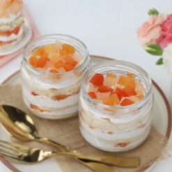 Fruit Fiesta Six Jars showcasing six glass jars filled with layered mixed fruit cakes and fresh fruit toppings, ideal for festive occasions and gift sets.
