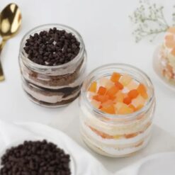 Fusion Chocochip Cake Duo showcasing two jars filled with rich chocochip fusion cake layers and creamy frosting, ideal for dessert lovers.