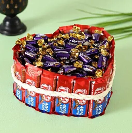 Heartfelt Kitkat Choclairs Delight – heart-shaped chocolate dessert featuring Kitkat and Choclairs