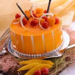 Mango Passion Cake with layered sponge, mango passion fruit jam filling, and cream cheese frosting topped with fresh mango slices
