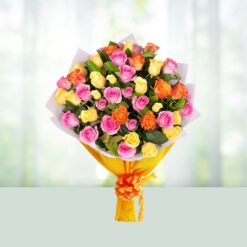 Colorful bouquet of mixed roses in red, pink, yellow, and orange shades arranged beautifully.