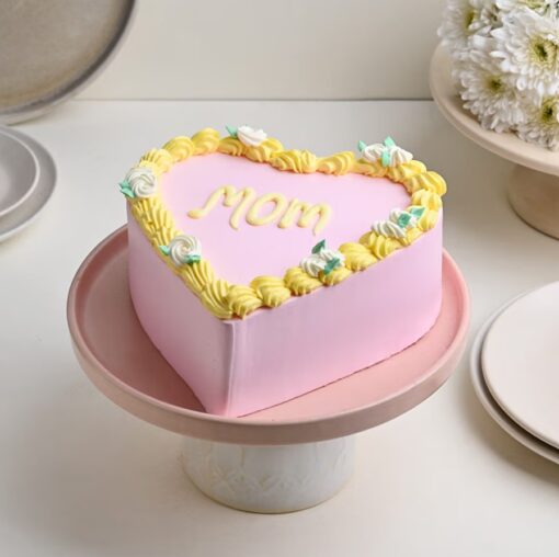 Mom’s Pink Heart Delight – pink heart-shaped cake with smooth buttercream frosting and delicate piped decorations.