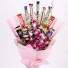 Bouquet of vibrant orchids elegantly arranged with assorted chocolates.