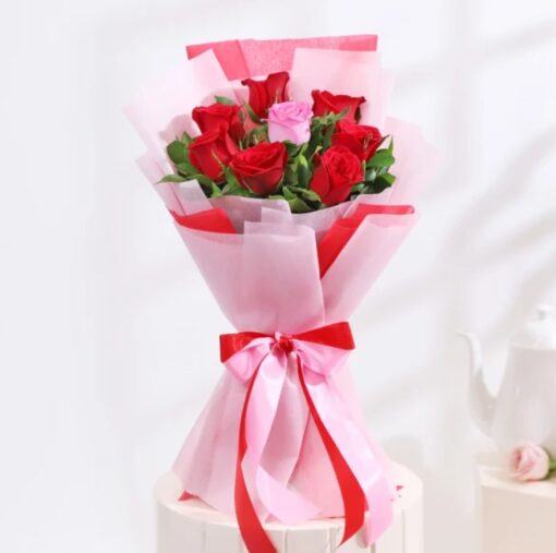 Playful Love Flower Bunch with light pink roses, lavender daisies, purple carnations, and white waxflower in a lavender vase