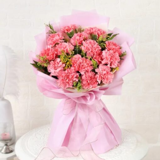 Regal Radiant Carnation Arrangement featuring vibrant pink, purple, and red carnations with lush greenery