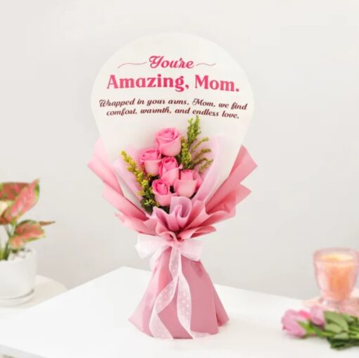 Mother’s Embrace Rose Bouquet featuring lush pink and red roses arranged in a cozy, inviting setting, symbolizing comfort and motherly love.
