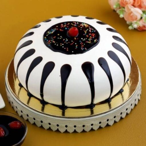 Traditional Black Forest Gateau with layered chocolate sponge, whipped cream, cherries, and chocolate shavings.