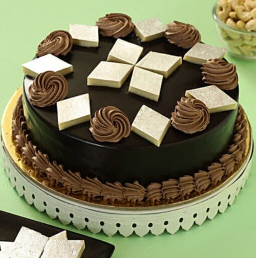Kaju Katli Chocolate Cake – chocolate cake layered with kaju katli cream and decorated with cashew flakes.