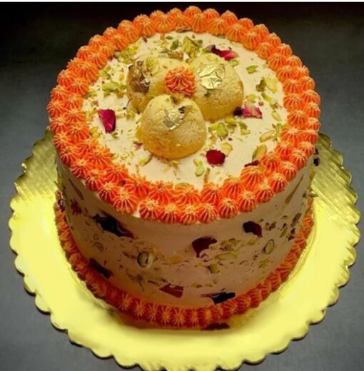 Regal Vanilla Rasmalai Delight – vanilla cake layered with rasmalai pieces, pistachios, and rose petals