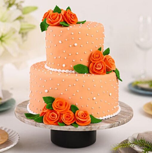 Peach Rose Elegance Cake – multi-tier cake decorated with peach buttercream roses and gold accents.