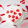 Love’s Radiant Heart Cake – heart-shaped vanilla cake with pink cream drips and fresh roses
