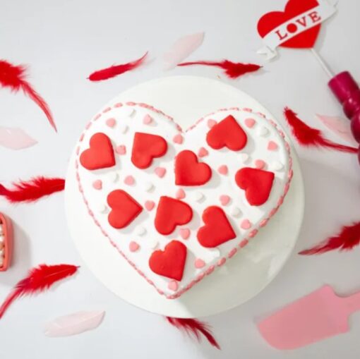 Love’s Radiant Heart Cake – heart-shaped vanilla cake with pink cream drips and fresh roses