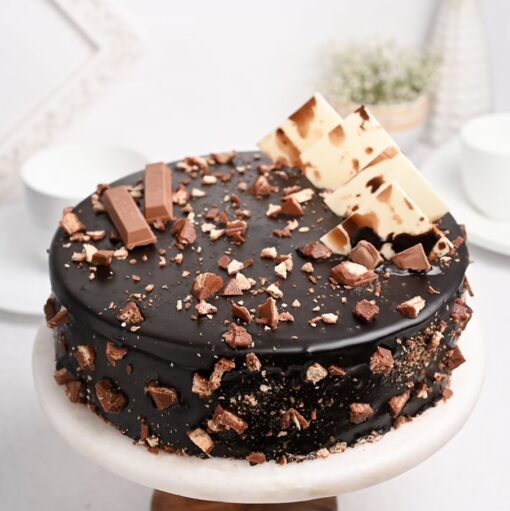 Kitkat Lover’s Delight Cake – chocolate cake layered with Kitkat bars and creamy frosting.