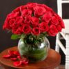 Radiant 40 Red Roses – forty fresh red roses arranged in a clear glass vase with green fillers.