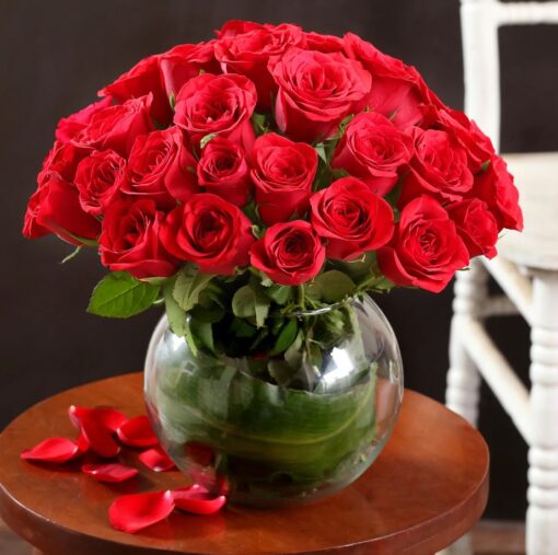 Radiant 40 Red Roses – forty fresh red roses arranged in a clear glass vase with green fillers.