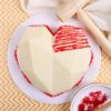 Heart-shaped piñata cake with chocolate shell and colorful candy filling inside