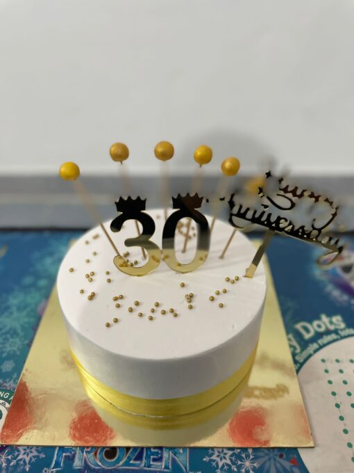 Elegant 30th birthday cake with floral decorations and golden accents