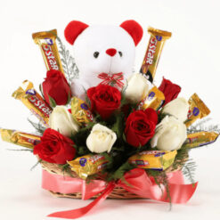 Basket of fresh red roses with assorted chocolates arranged elegantly