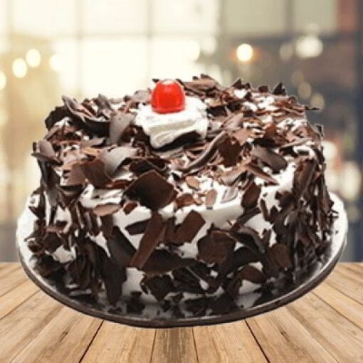 Black Forest Choco Delight cake with chocolate chips, cherries, and whipped cream.
