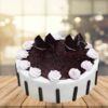 Blueberry Burst Cake topped with fresh blueberries and a light glaze.