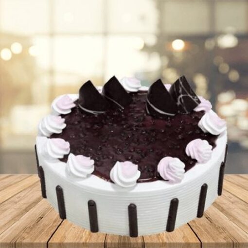 Blueberry Burst Cake topped with fresh blueberries and a light glaze.