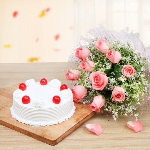 Pink Rose Vanilla Celebration bouquet with fresh pink roses and a vanilla flower cake beautifully presented together.