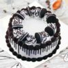 Artistic layered cake decorated with a colorful medley of fresh, seasonal fruits.