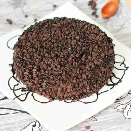 Elegant Choco Chip Garnish—artfully arranged chocolate chips on a cake for a decorative finish.