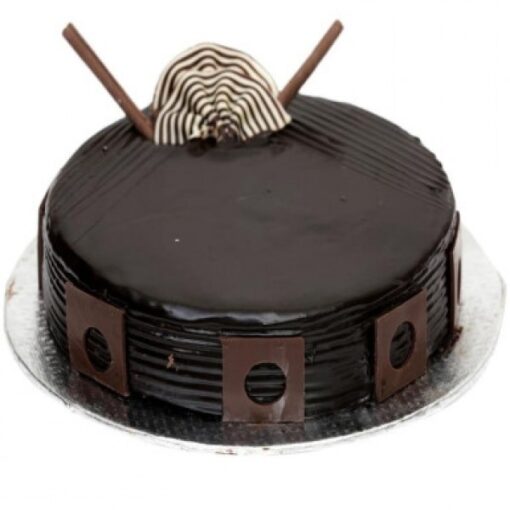 Rich Dark Chocolate Delight cake with glossy ganache and chocolate shavings.