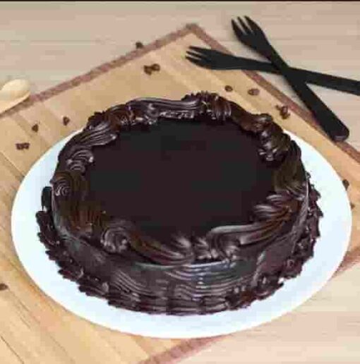 Ultimate Chocolate Cake—rich, moist chocolate cake with glossy ganache and elegant decoration.