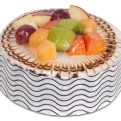 Vanilla Fruit Medley Cake with fresh strawberries, blueberries, raspberries, and creamy vanilla frosting.