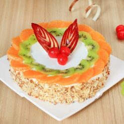 Designer heart-shaped red velvet cake with elegant decorative accents.