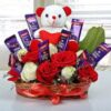 Elegant gift hamper with gourmet treats, chocolates, and floral decorations.