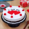 Romantic Valentine Cake decorated with vanilla flowers, rose motifs, and heart-shaped chocolate accents.