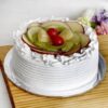 Elegant layered cake decorated with a colorful medley of fresh fruits.