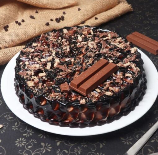 Ultimate Kitkat Chocolate Cake with chocolate layers and Kitkat bar decoration.