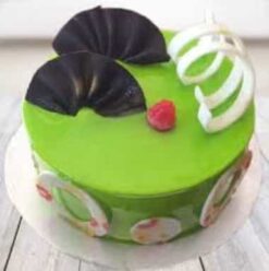 Elegant kiwi cake decorated with delicate floral accents.
