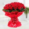 Grand bouquet of long-stemmed red roses arranged elegantly for gifting.