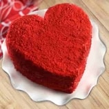 Designer heart-shaped red velvet cake with elegant decoration.