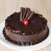 Elegant celebration cake decorated with crunchy toppings and creamy frosting.